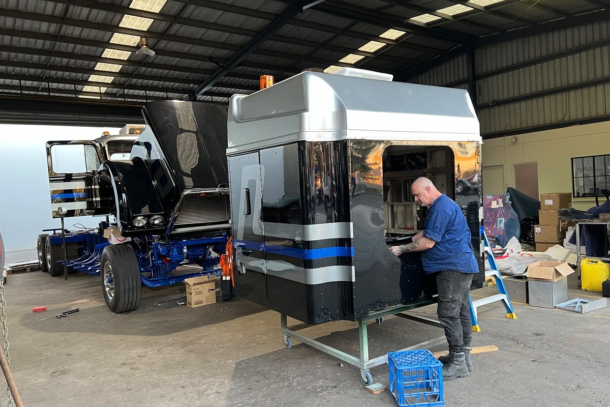 Freshly painted black cab in workshop